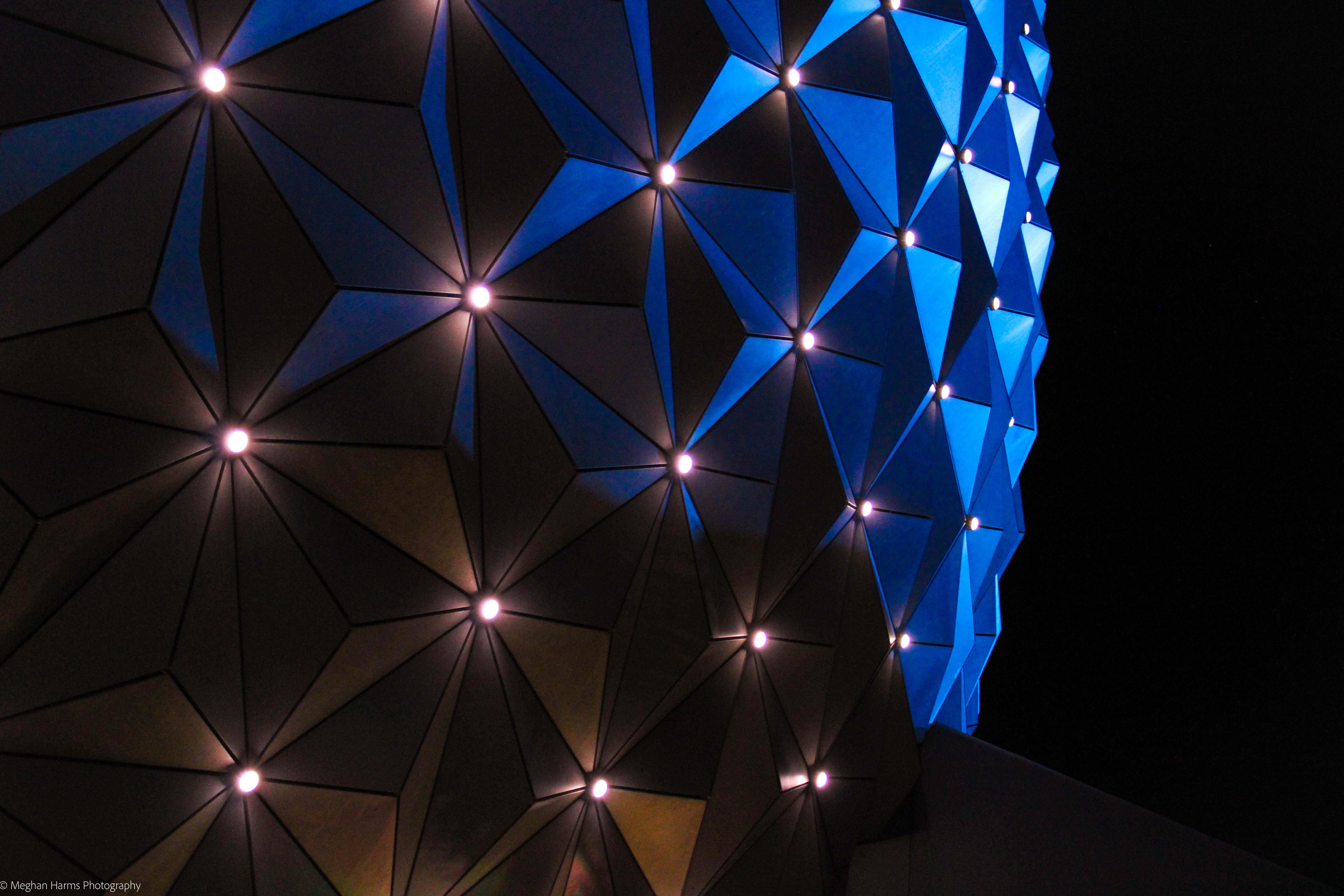 Close up of Epcot's Spaceship Earth at night with white lights